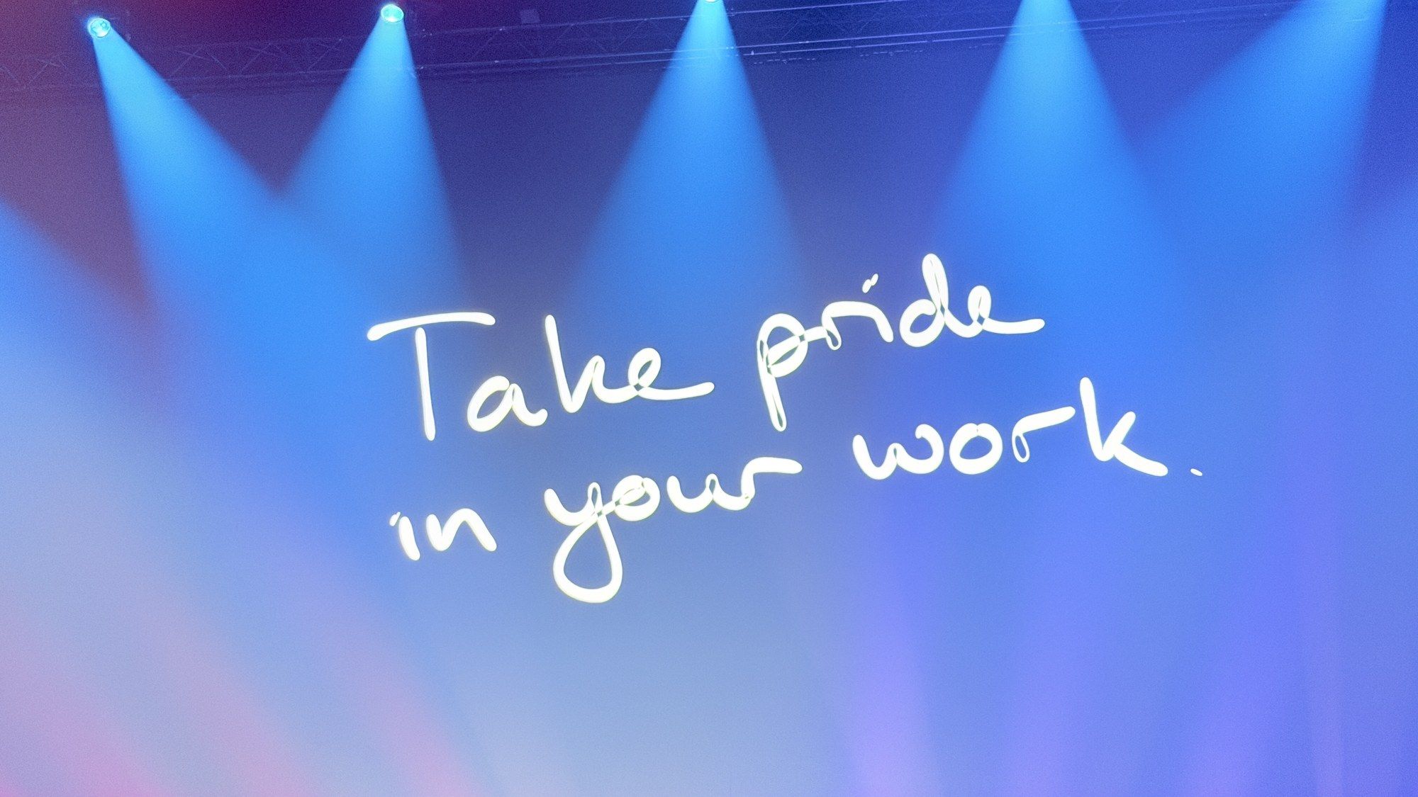 A keynote screen with handwritten words: Take pride in your work.