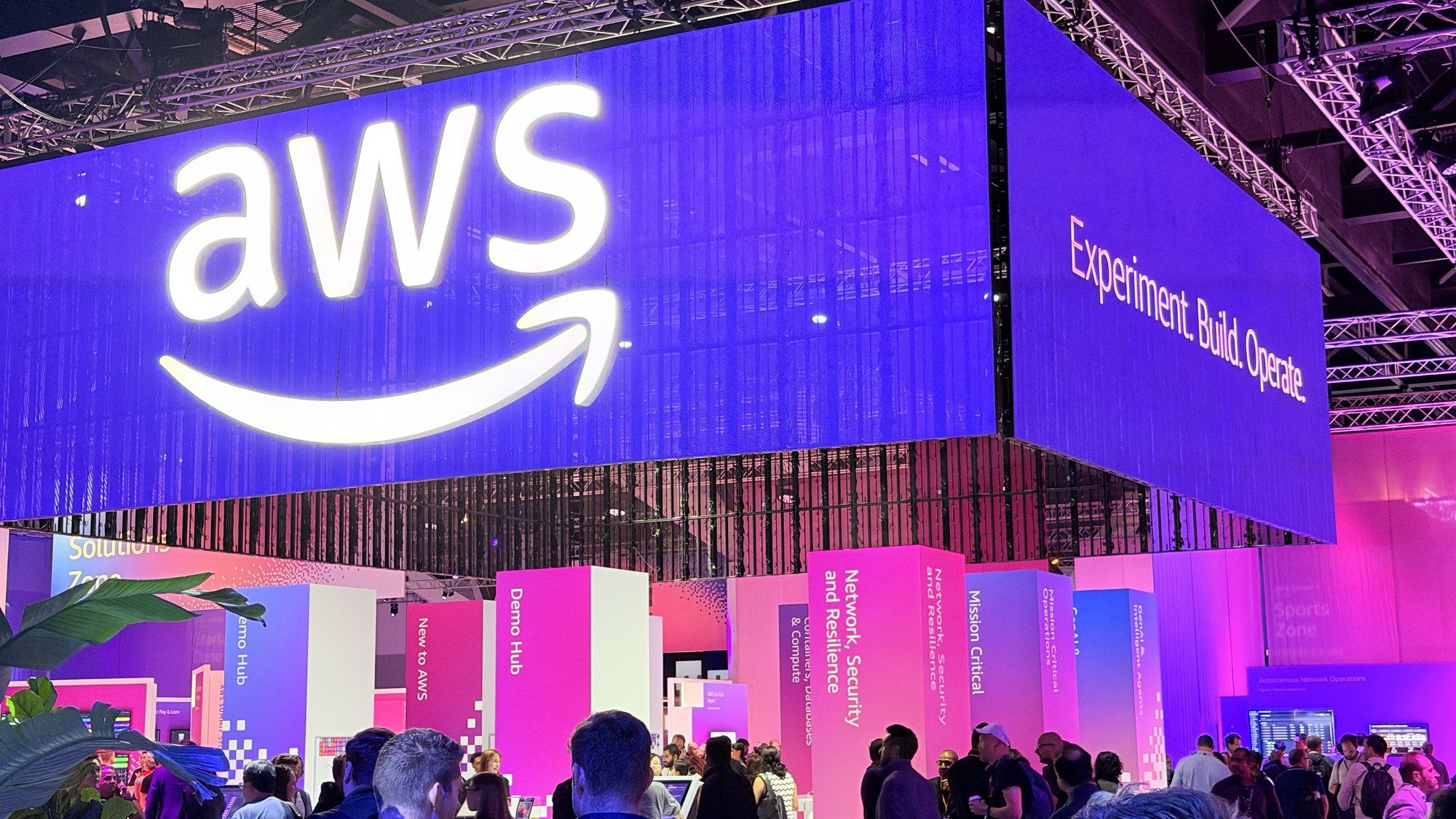 A giant glowing AWS sign hanging over the expo floor.