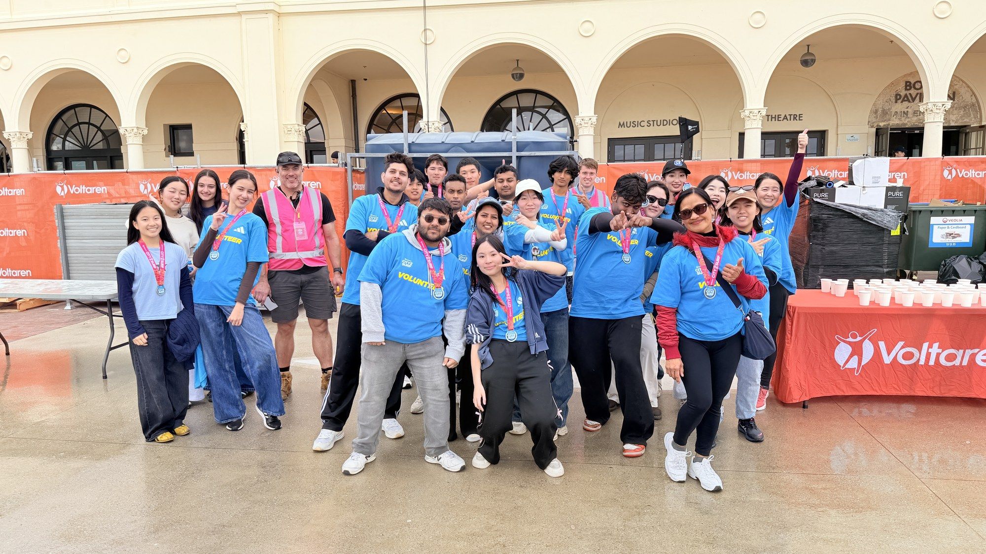 City2Surf 2026 volunteer crew in blue shirts outside Bondi Pavilion.