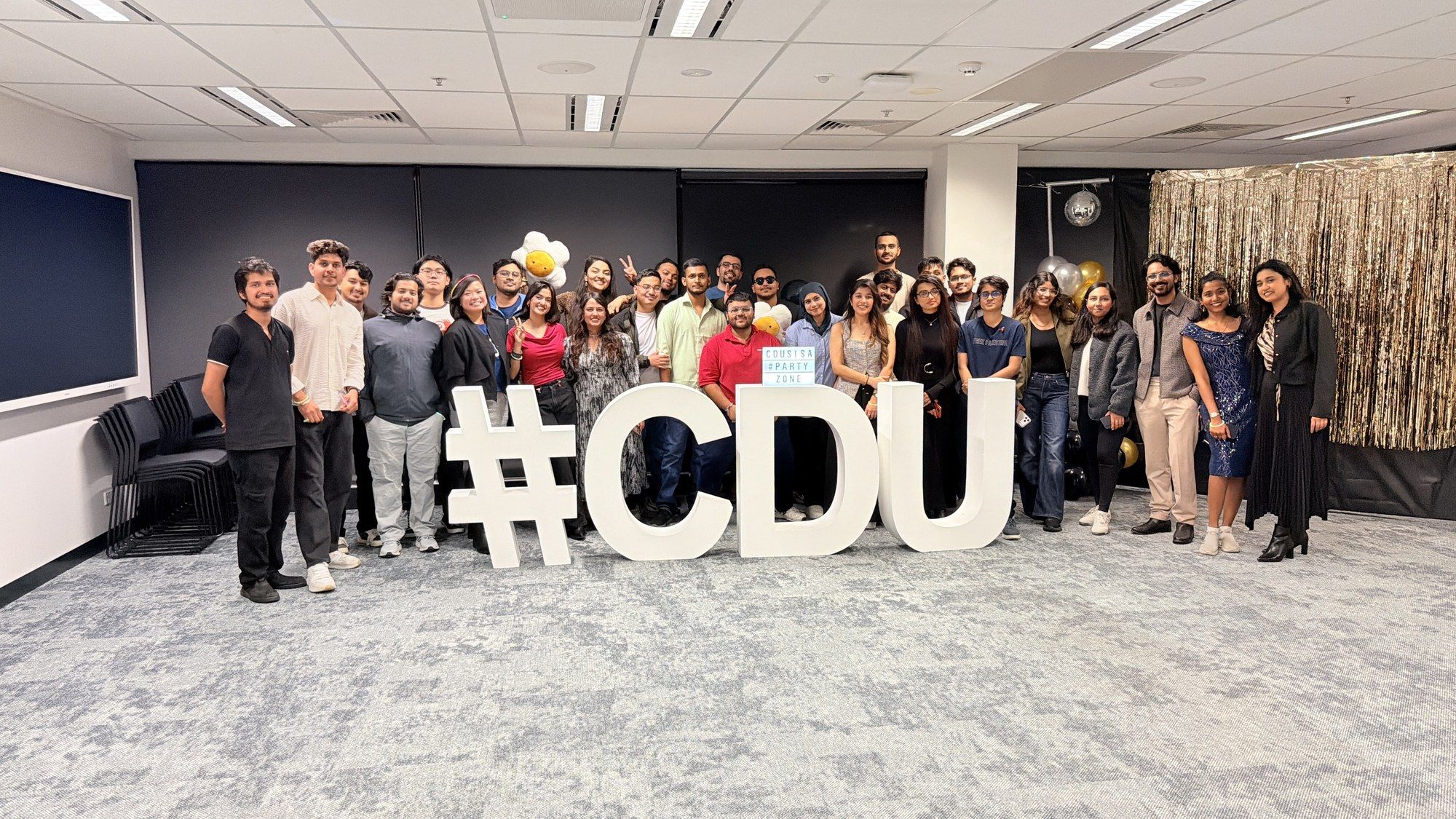 Students behind large #CDU letters at the SISA End of Semester Party.