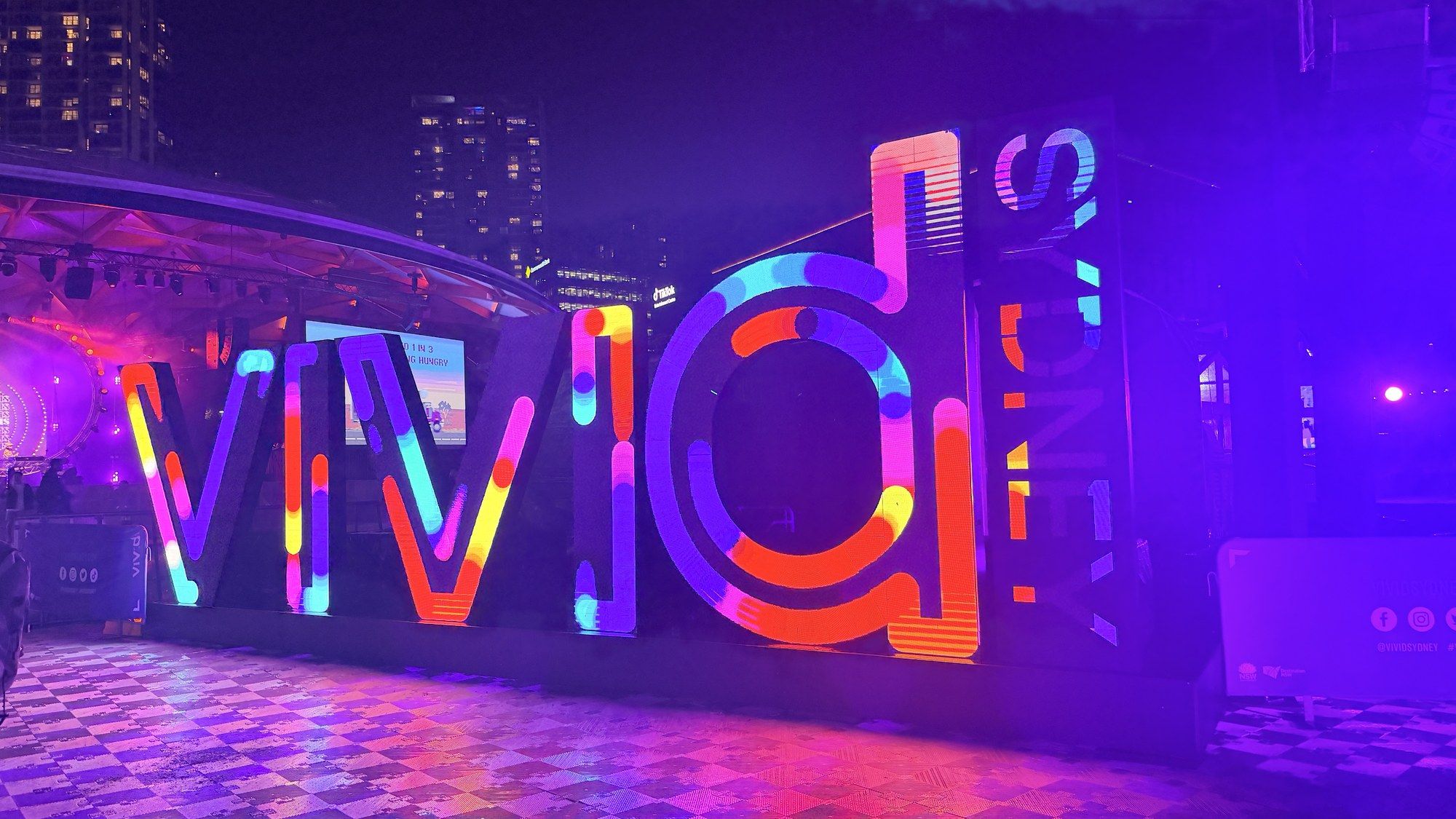 The neon Vivid Sydney sign glowing purple and orange.